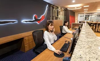 A professional receptionist answering phone calls at Servcorp, One Museum Place, Shanghai, China.